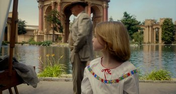 Movie still from “Big Eyes” (2014), directed by Tim Burton – A little girl standing next to an older man in front of a pond; Wide shot, Over the shoulder angle