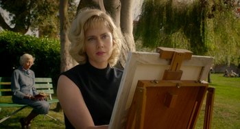 Movie still from “Big Eyes” (2014), directed by Tim Burton – A woman in a black shirt is holding an easel; Medium shot, Over the shoulder angle