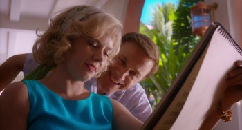 Movie still from “Big Eyes” (2014), directed by Tim Burton – A man and a woman sitting next to each other in front of a window; Close Up shot, Low angle