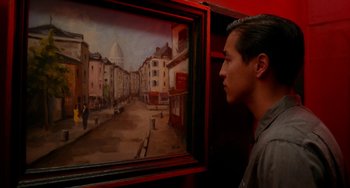 Movie still from “Big Eyes” (2014), directed by Tim Burton – A man standing in front of a painting of a city; Close Up shot, Over the shoulder angle
