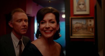 Movie still from “Big Eyes” (2014), directed by Tim Burton – A woman in a black dress smiling for the camera; Close Up shot, Over the shoulder angle