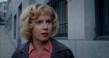 Movie still from “Big Eyes” (2014), directed by Tim Burton – A woman with blonde hair wearing a pink shirt; Close Up shot, Over the shoulder angle