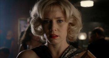 Movie still from “Big Eyes” (2014), directed by Tim Burton – A woman with blonde curly hair wearing a black and white dress; Close Up shot, Low angle
