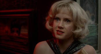 Movie still from “Big Eyes” (2014), directed by Tim Burton – A woman with blonde hair wearing a black top; Close Up shot, Over the shoulder angle