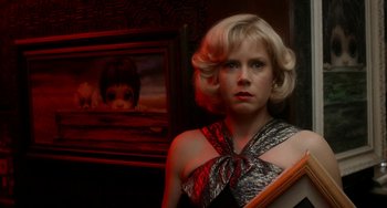 Movie still from “Big Eyes” (2014), directed by Tim Burton – A woman with blonde curly hair wearing a black top; Close Up shot, Low angle