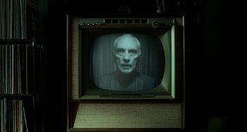 Movie still from “Big Eyes” (2014), directed by Tim Burton – An old television with a man's face on it; Close Up shot, Low angle