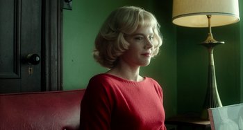 A woman with blonde hair wearing a red shirt