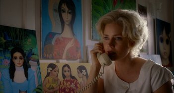 Movie still from “Big Eyes” (2014), directed by Tim Burton – A woman talking on a phone in front of a painting; Close Up shot, Low angle