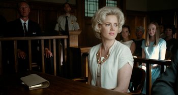 Movie still from “Big Eyes” (2014), directed by Tim Burton – A woman sitting at a table in front of a judge; Close Up shot, Low angle