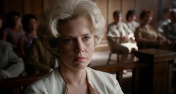 Movie still from “Big Eyes” (2014), directed by Tim Burton – An older woman in a white suit stares into the camera; Close Up shot, Low angle