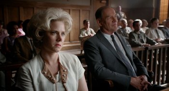 Movie still from “Big Eyes” (2014), directed by Tim Burton – A woman and a man sitting in a courtroom; Medium shot, Low angle