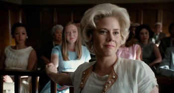 Movie still from “Big Eyes” (2014), directed by Tim Burton – A woman in a white dress and a group of people in the background; Close Up shot, Low angle