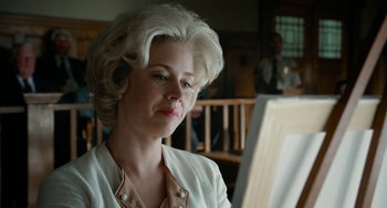 Movie still from “Big Eyes” (2014), directed by Tim Burton – A woman sitting in front of an easel looking at a painting; Close Up shot, Low angle