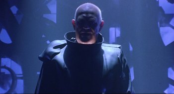 Movie still from “Bill & Ted's Bogus Journey” (1991), directed by Peter Hewitt – A man with a bald head wearing a black jacket; Medium shot, Low angle