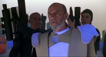 Movie still from “Bill & Ted's Bogus Journey” (1991), directed by Peter Hewitt – A man with a beard holding a gun in his hand; Medium shot, Low angle