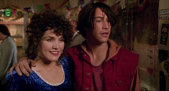 Movie still from “Bill & Ted's Bogus Journey” (1991), directed by Peter Hewitt – A man and a woman standing next to each other in a room; Close Up shot, Over the shoulder angle