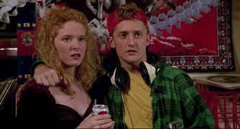 Movie still from “Bill & Ted's Bogus Journey” (1991), directed by Peter Hewitt – A man and a woman are posing for a picture; Medium shot, Low angle