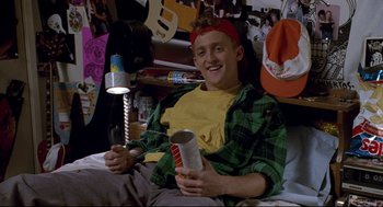 Movie still from “Bill & Ted's Bogus Journey” (1991), directed by Peter Hewitt – A man sitting on a bed holding a can of soda; Medium shot, Overhead angle