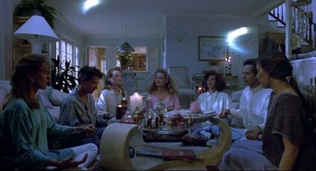 Movie still from “Bill & Ted's Bogus Journey” (1991), directed by Peter Hewitt – A group of people sitting around a living room table; Wide shot, High angle