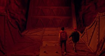 Movie still from “Bill & Ted's Bogus Journey” (1991), directed by Peter Hewitt – Two people walking up a ramp in a dark room; Wide shot, Overhead angle