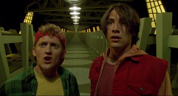 Movie still from “Bill & Ted's Bogus Journey” (1991), directed by Peter Hewitt – Two people standing next to each other in a hallway; Medium shot, Low angle