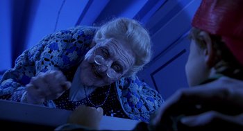 Movie still from “Bill & Ted's Bogus Journey” (1991), directed by Peter Hewitt – An old woman with a big smile on her face; Close Up shot, Over the shoulder angle