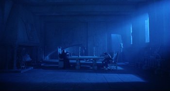 Movie still from “Bill & Ted's Bogus Journey” (1991), directed by Peter Hewitt – Two people sitting at a long table in a dark room; Extreme Wide shot, Over the shoulder angle