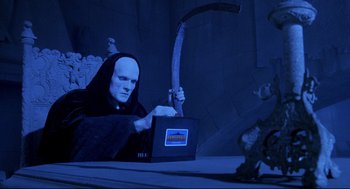 Movie still from “Bill & Ted's Bogus Journey” (1991), directed by Peter Hewitt – A person with a mask on and a laptop; Medium shot, Low angle