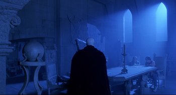 Movie still from “Bill & Ted's Bogus Journey” (1991), directed by Peter Hewitt – A man in a black robe stands in front of a window; Wide shot, Over the shoulder angle