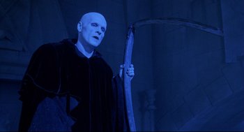 Movie still from “Bill & Ted's Bogus Journey” (1991), directed by Peter Hewitt – A man dressed as voldemort holding a staff; Medium shot, Low angle