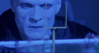 Movie still from “Bill & Ted's Bogus Journey” (1991), directed by Peter Hewitt – A man's face in front of a football goal post; Extreme Close Up shot, Low angle