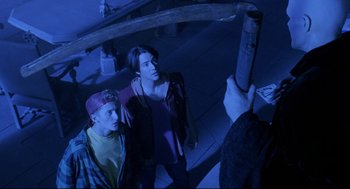 Movie still from “Bill & Ted's Bogus Journey” (1991), directed by Peter Hewitt – Two men looking up at a man holding an object; Medium shot, Over the shoulder angle