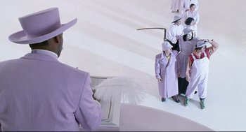 Movie still from “Bill & Ted's Bogus Journey” (1991), directed by Peter Hewitt – A group of people dressed in purple and holding a white umbrella; Wide shot, High angle