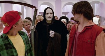 Movie still from “Bill & Ted's Bogus Journey” (1991), directed by Peter Hewitt – A group of people dressed up in costumes; Medium shot, Over the shoulder angle