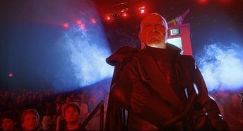 Movie still from “Bill & Ted's Bogus Journey” (1991), directed by Peter Hewitt – A man dressed as darth sidious from star wars in front of an audience; Medium shot, Low angle