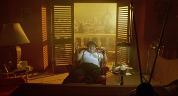 Movie still from “Bill & Ted's Bogus Journey” (1991), directed by Peter Hewitt – A woman sitting on a chair in front of a window; Wide shot, High angle