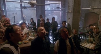 Movie still from “Bill & Ted's Bogus Journey” (1991), directed by Peter Hewitt – A group of people sitting around a table eating food; Wide shot, High angle