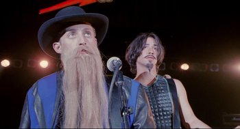 Movie still from “Bill & Ted's Bogus Journey” (1991), directed by Peter Hewitt – A man with a long beard and a man with long hair; Close Up shot, Low angle