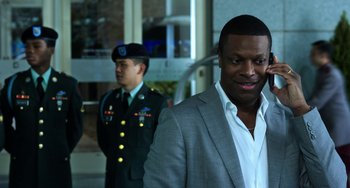 Movie still from “Billy Lynn's Long Halftime Walk” (2016), directed by Ang Lee – A man standing next to another man in a uniform; Close Up shot, Over the shoulder angle