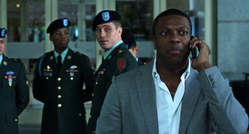 Movie still from “Billy Lynn's Long Halftime Walk” (2016), directed by Ang Lee – A group of men standing next to each other in suits; Close Up shot, Over the shoulder angle