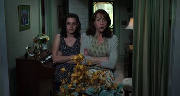 Movie still from “Billy Lynn's Long Halftime Walk” (2016), directed by Ang Lee – Two women standing next to each other in a room; Medium shot, High angle