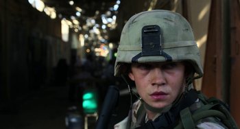 Movie still from “Billy Lynn's Long Halftime Walk” (2016), directed by Ang Lee – A man in a military uniform is holding a rifle; Close Up shot, Low angle
