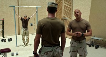 Movie still from “Billy Lynn's Long Halftime Walk” (2016), directed by Ang Lee – A group of men standing next to each other; Medium shot, Over the shoulder angle