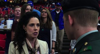 Movie still from “Billy Lynn's Long Halftime Walk” (2016), directed by Ang Lee – A woman talking to a man in a crowd of onlookers at an event; Close Up shot, Over the shoulder angle