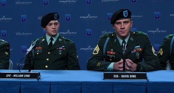 Movie still from “Billy Lynn's Long Halftime Walk” (2016), directed by Ang Lee – Two men in military fatigues sitting in front of microphones; Medium shot, Low angle