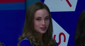 Movie still from “Billy Lynn's Long Halftime Walk” (2016), directed by Ang Lee – A beautiful young lady with long brown hair and blue eyes; Close Up shot, Over the shoulder angle