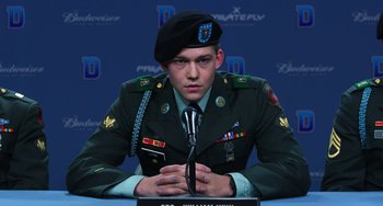 Movie still from “Billy Lynn's Long Halftime Walk” (2016), directed by Ang Lee – A man in a military uniform sitting in front of microphones; Close Up shot, Low angle
