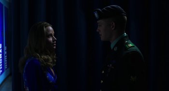 Movie still from “Billy Lynn's Long Halftime Walk” (2016), directed by Ang Lee – A man and a woman in military dress uniforms; Medium shot, Low angle
