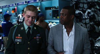 Movie still from “Billy Lynn's Long Halftime Walk” (2016), directed by Ang Lee – Two men standing next to each other in a room; Medium shot, Over the shoulder angle