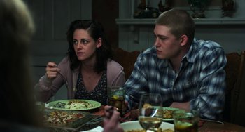 Movie still from “Billy Lynn's Long Halftime Walk” (2016), directed by Ang Lee – A man and a woman sitting at a table with plates of food on it; Medium shot, High angle